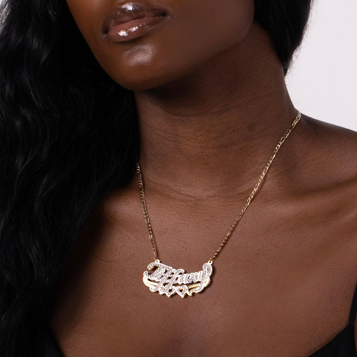 Necklace with a pendant worn by a person against a neutral background