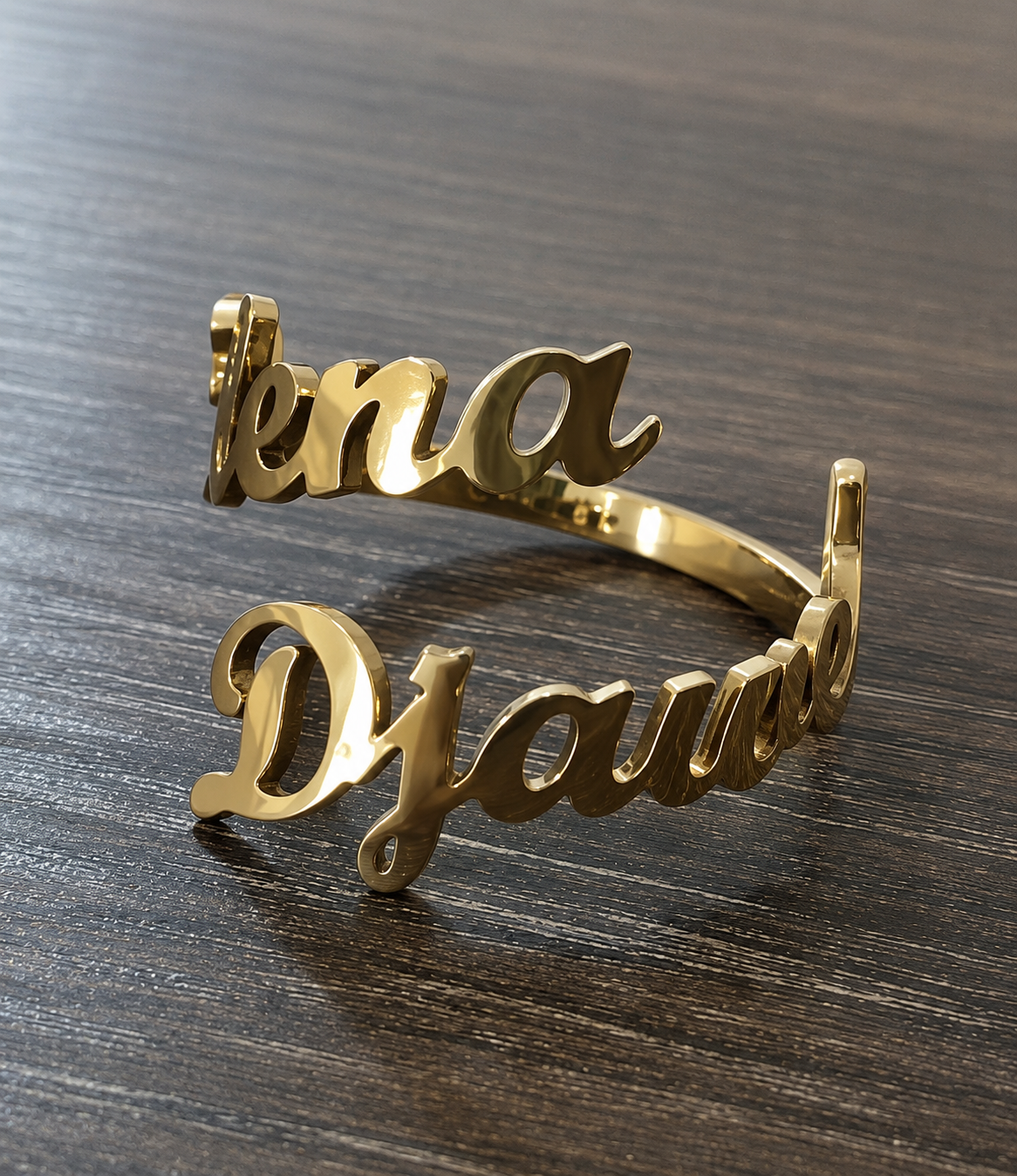 Gold name bracelet on a wooden surface