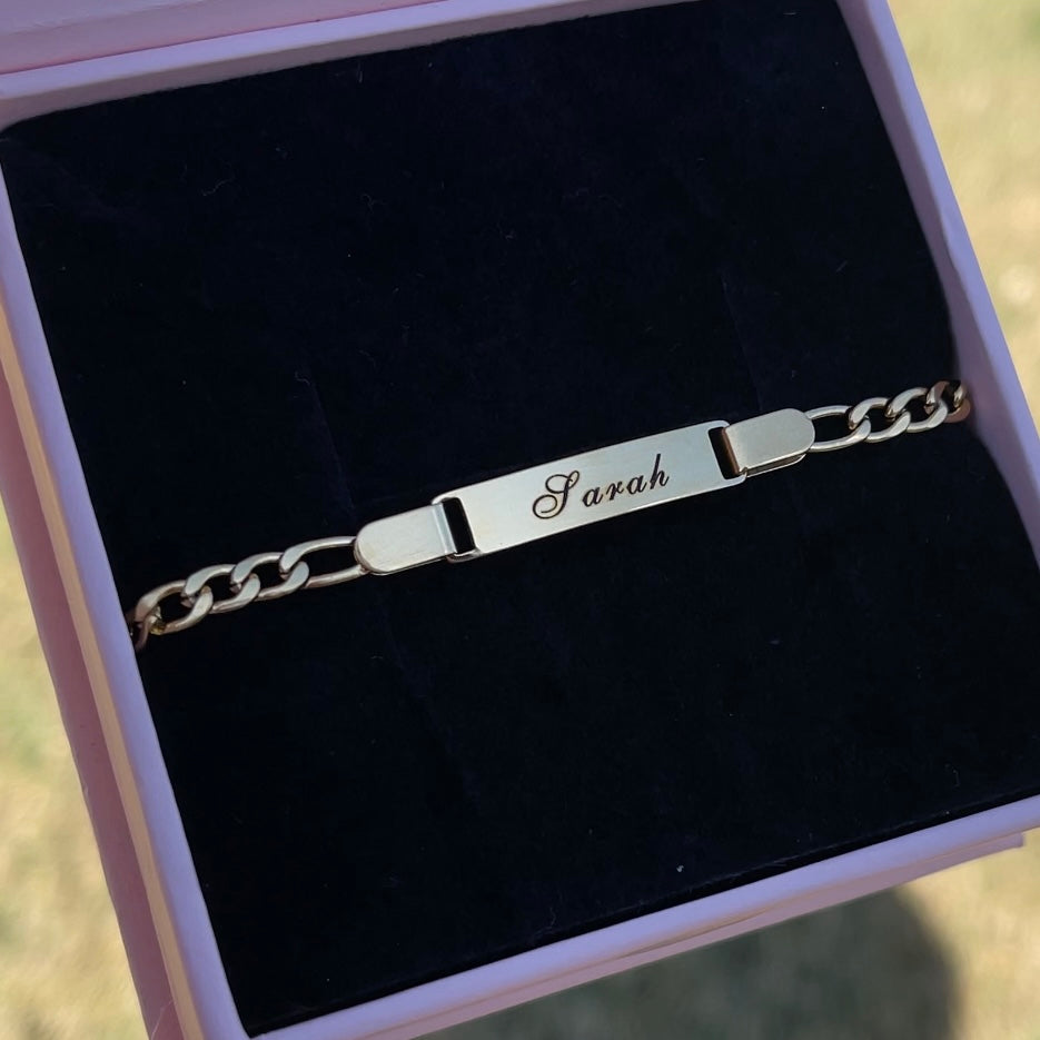 Silver bracelet with engraved name 'Sarah' in a black box