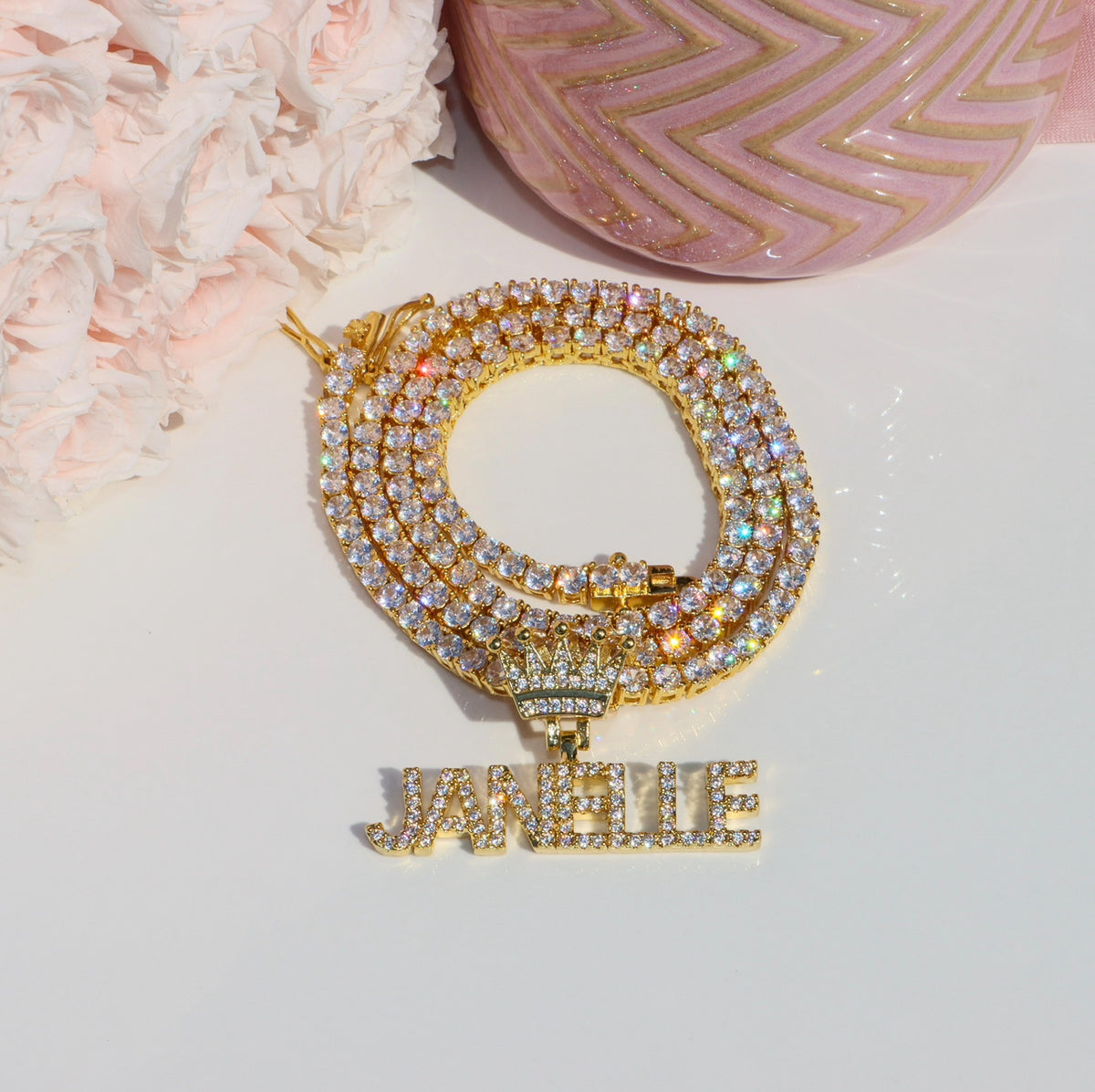 Gold bracelet with diamond accents and 'JANELLE' charm on a light background