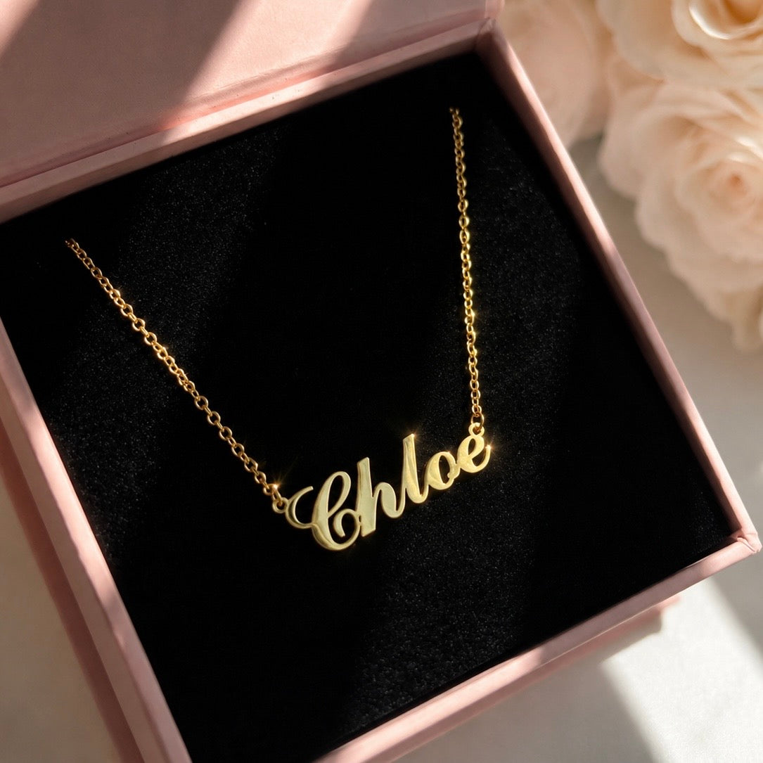 Gold 'Chloe' necklace in a pink box with black interior