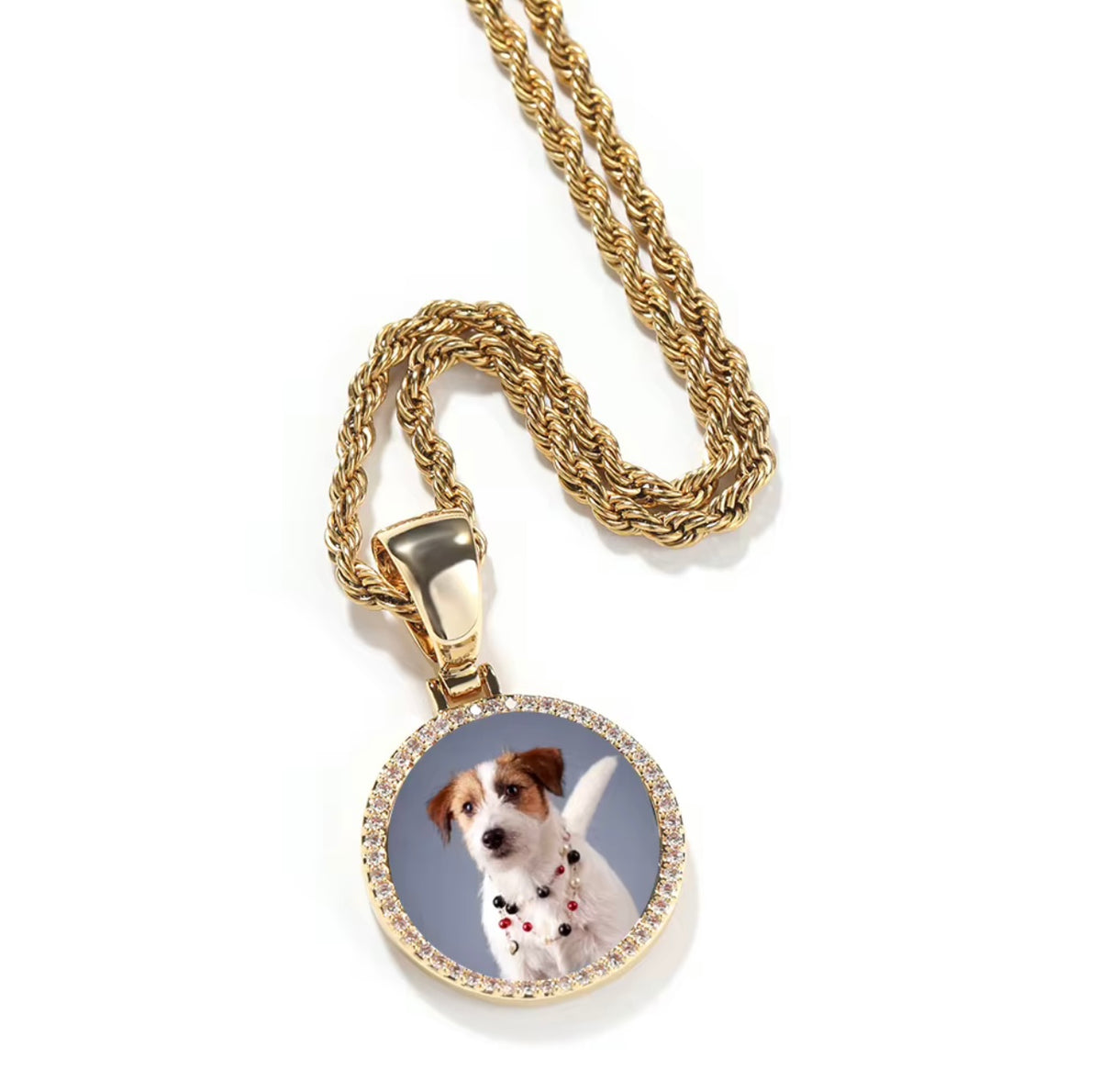 A gold finish custom photo pendant necklace with a sparkling cubic zirconia border and a picture of a dog in the center, displayed on a white background.